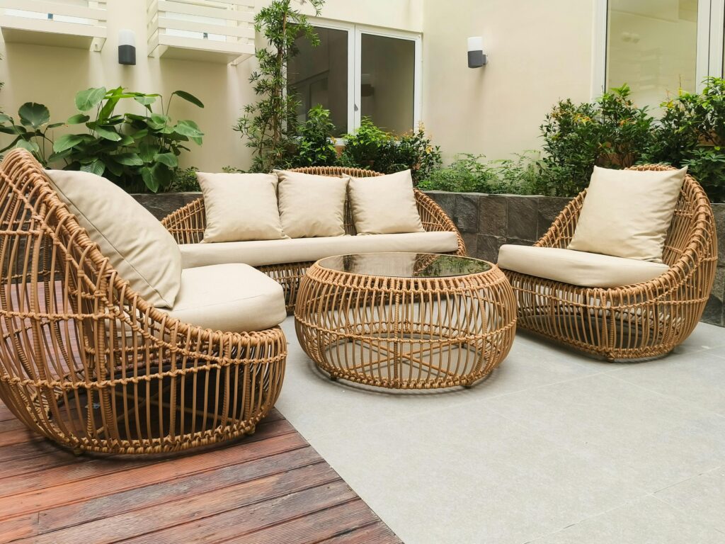 Smart Home Décor Ideas for Modern Living Outdoor seating with rattan furniture set in a lush garden patio, ideal for relaxation and gatherings.