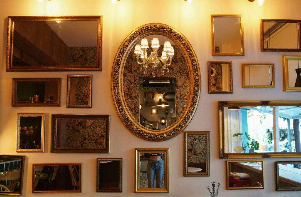 Create a Stylish & Comfortable Home Charming café wall adorned with a variety of framed mirrors and a chandelier.